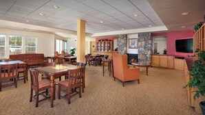 A spacious living area with a fireplace, a television, and a bookshelf. - Perfect Resort in Charming Solvang California (Solvang)