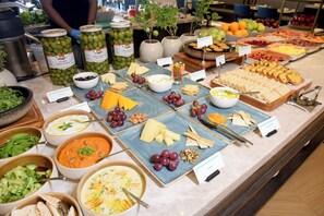 Indulge in a diverse spread of dips, cheeses, crackers, and fresh fruits.