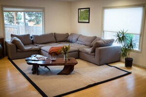 Relax in this inviting living space with a comfortable L-shaped sofa, coffee table, and a beautiful view.