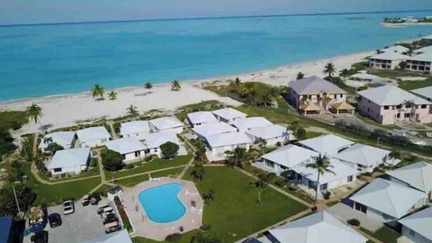 A coastal residential area with houses, a swimming pool, and a beach. - Sea Biscuit Ocean Villa 911 (Abaco)