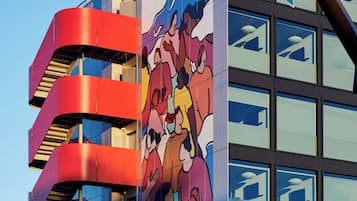 A building with a mural of cartoon characters, a sign for Meta Way, and Constitution Dr.