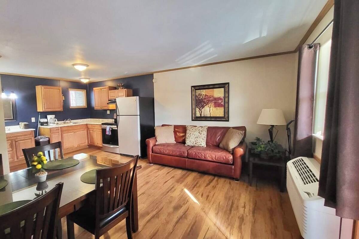 A compact living space with a kitchen, dining area, and a sofa.