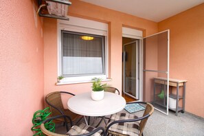 Enjoy a peaceful retreat in this serene outdoor space with a round table and two wicker chairs.
