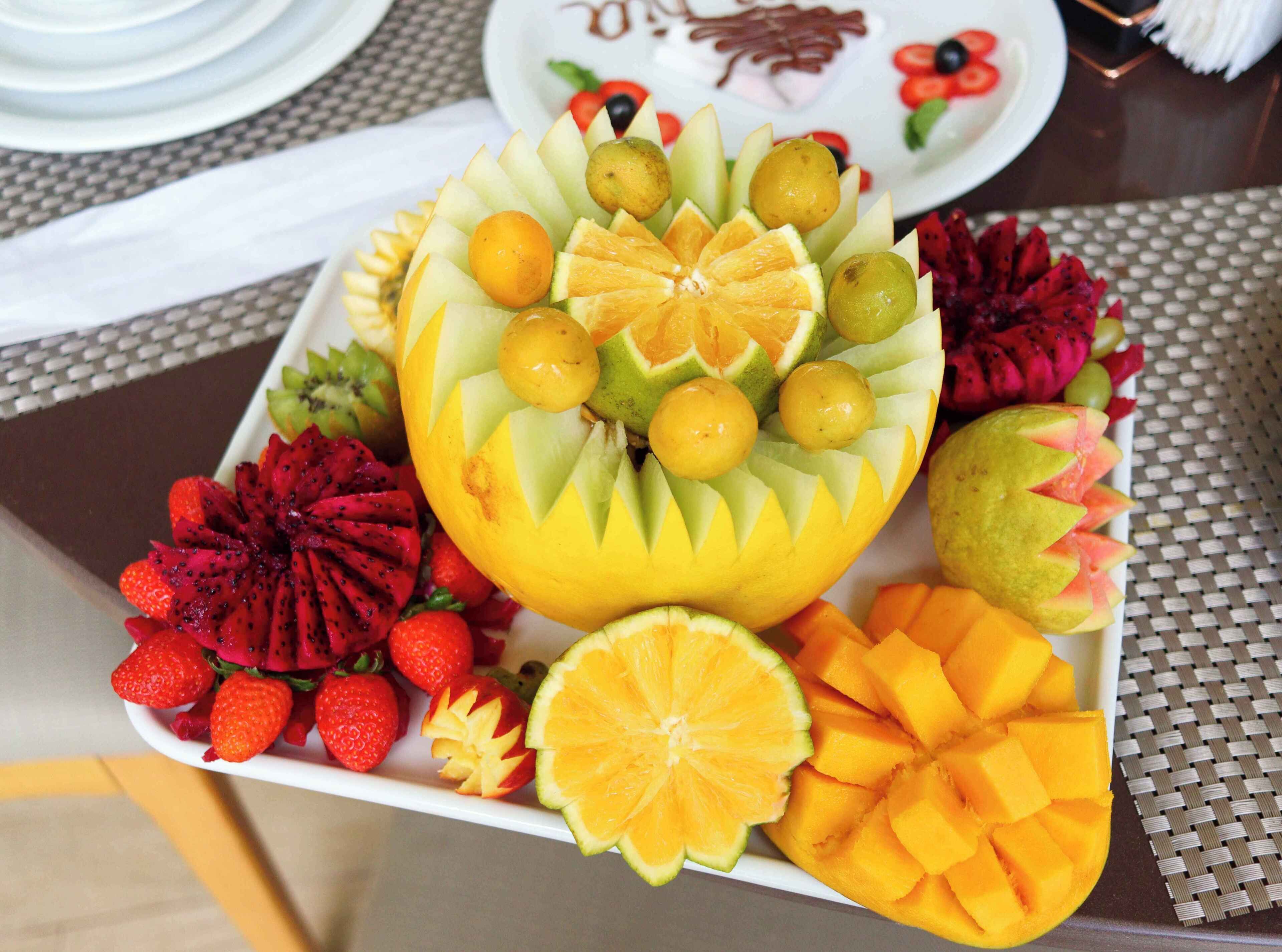 A fruit platter with various fruits arranged artistically.