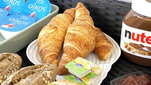 A table with croissants, a jar of Nutella, and containers of yogurt. - B&B Albufeira City Room Junior with Private Bathroom (Albufeira)