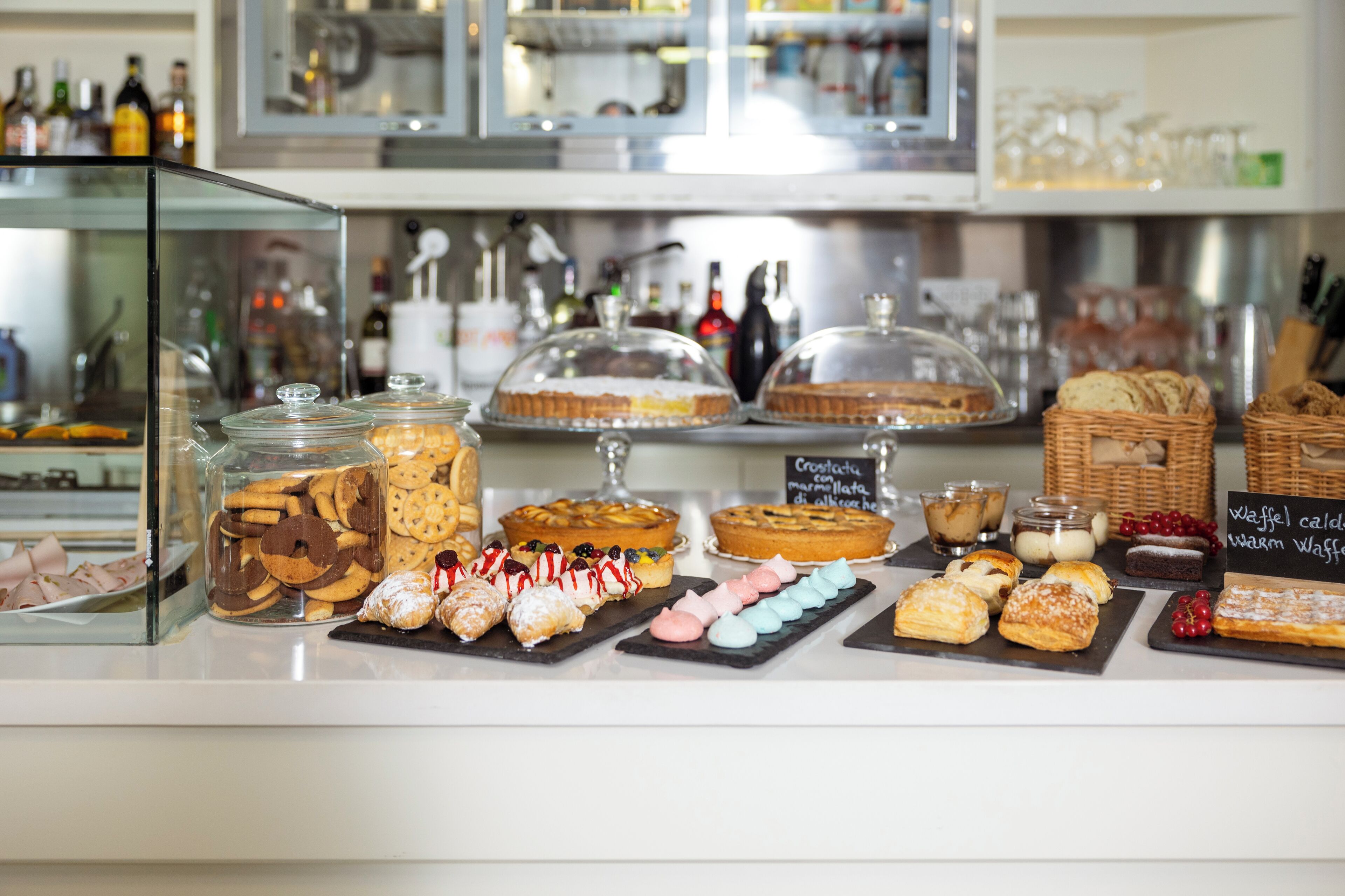 A bakery display with various pastries and desserts.