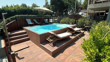 Seasonal outdoor pool, open 9:00 AM to 8:00 PM, pool loungers
