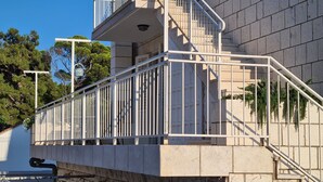 A staircase with white railings leading to a building entrance. - Apartment Solvit - Three Bedroom Apartment with Terrace (Dubrovnik)
