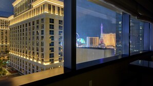A high-rise hotel with a view of the Eiffel Tower and other city landmarks.