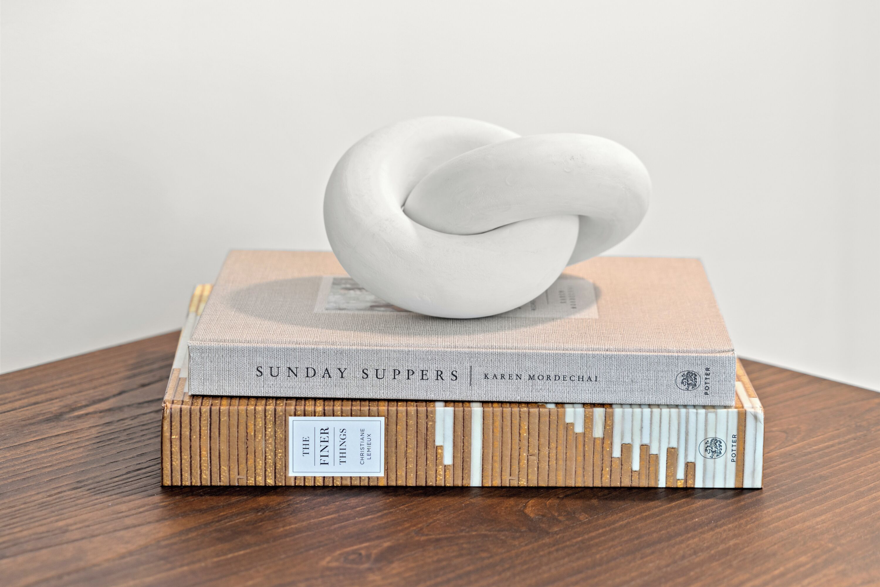A stack of books on a wooden surface.