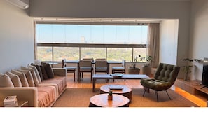 Premium Apartment, 1 King Bed | Living area | 32-inch Smart TV with cable channels