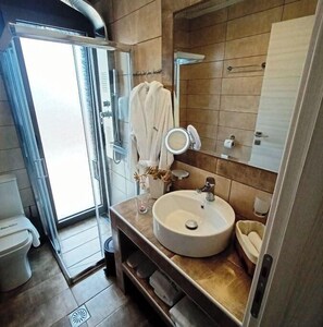 Shower, towels, soap, toilet paper