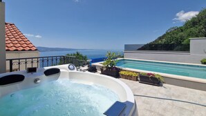 A hot tub with a view of the sea, a pool, and a terrace with potted plants. - Pet friendly home in Stanici (Stanici)