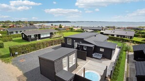 A residential area with modern houses, a swimming pool, and a view of the sea. - 3 bedroom nice home in Rønde (Rønde)