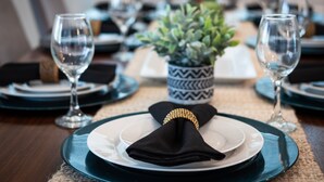 A dining table set with plates, glasses, and a centerpiece. - Family Ready Pool Villa with Star Wars Game Room, Karaoke (Kissimmee)