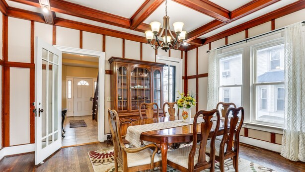 A dining room with a wooden table, chairs, a chandelier, and a cabinet. - Pet-Friendly Penn Yan Home: Wineries, Parks, Lakes (Penn Yan)