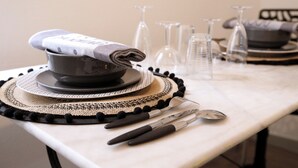 A dining table set with a pot, plates, glasses, and cutlery. - THE ISLE PARADISE (Saint-Quentin)