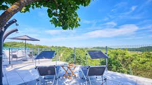 A rooftop terrace with two foldable chairs, a table, and two solar panels. - 2 bedroom lovely home in Kladje (Kladje)