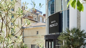 A hotel named 'Hotel Indigo' with a modern facade, large windows, and a signboard. - Hotel Indigo Bordeaux Centre Chartrons by IHG (Bordeaux)