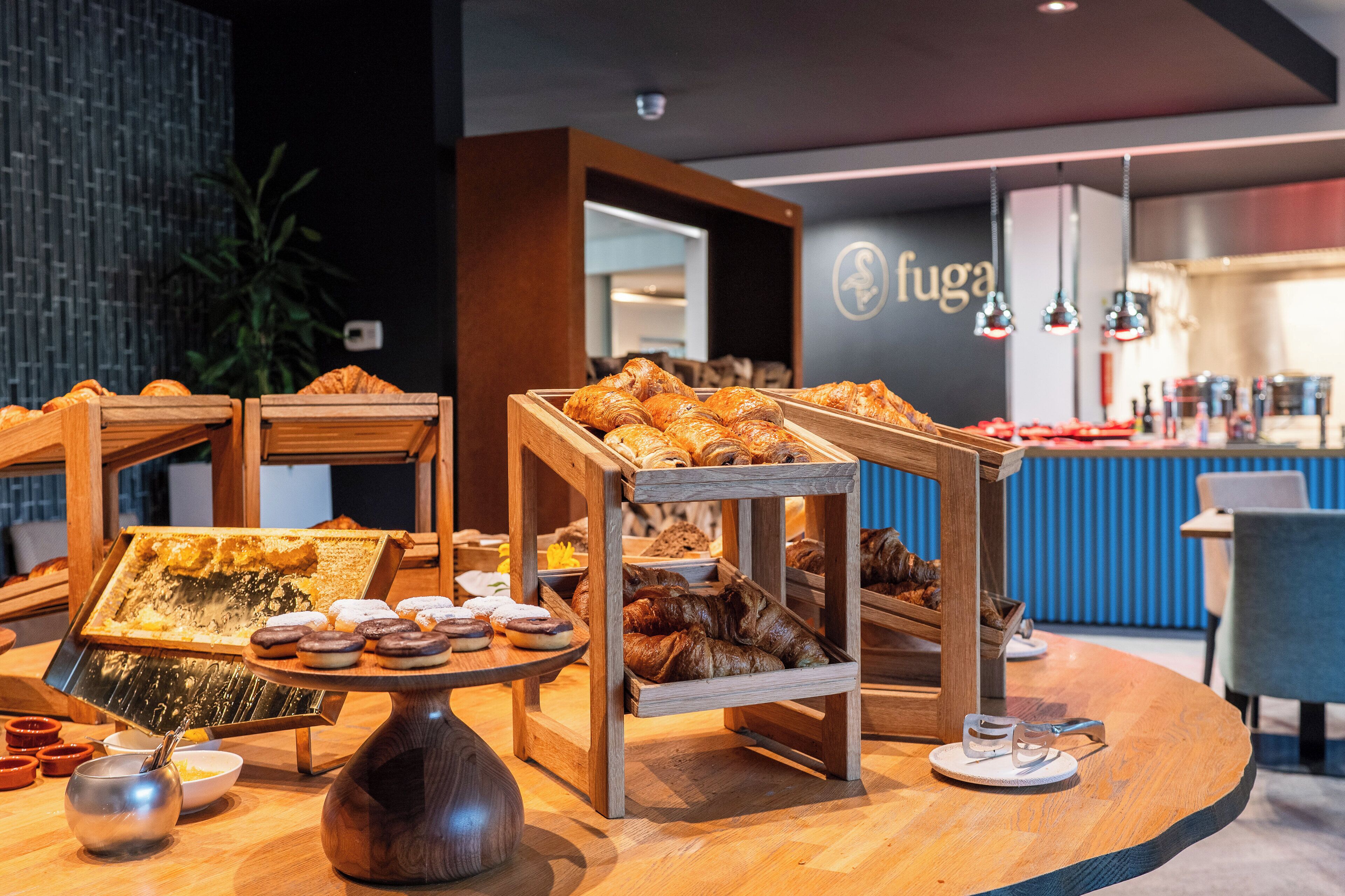 A breakfast buffet with various pastries and a coffee station.