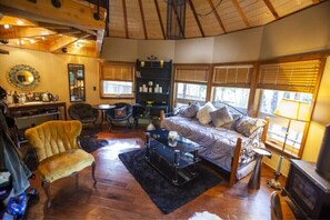 Cozy retreat with a comfortable bed, fireplace, and bookshelf.