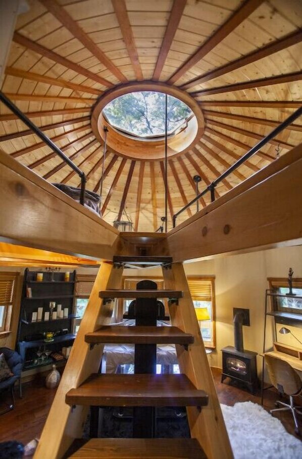 Enjoy a warm ambiance with a fireplace and natural light pouring in through the central skylight.