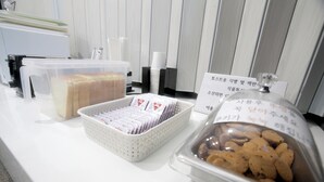 A buffet setup with various food items and containers, including sandwiches, cookies, and a beverage dispenser. - Ulsan Palace (Ulsan)