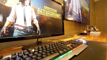 Two monitors displaying 'PlayerUnknown's Battlegrounds' on a desk with a keyboard and mouse.