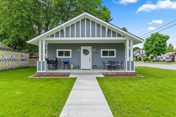 A two-story house with a front porch, a mailbox, and a number 1319 on the door.