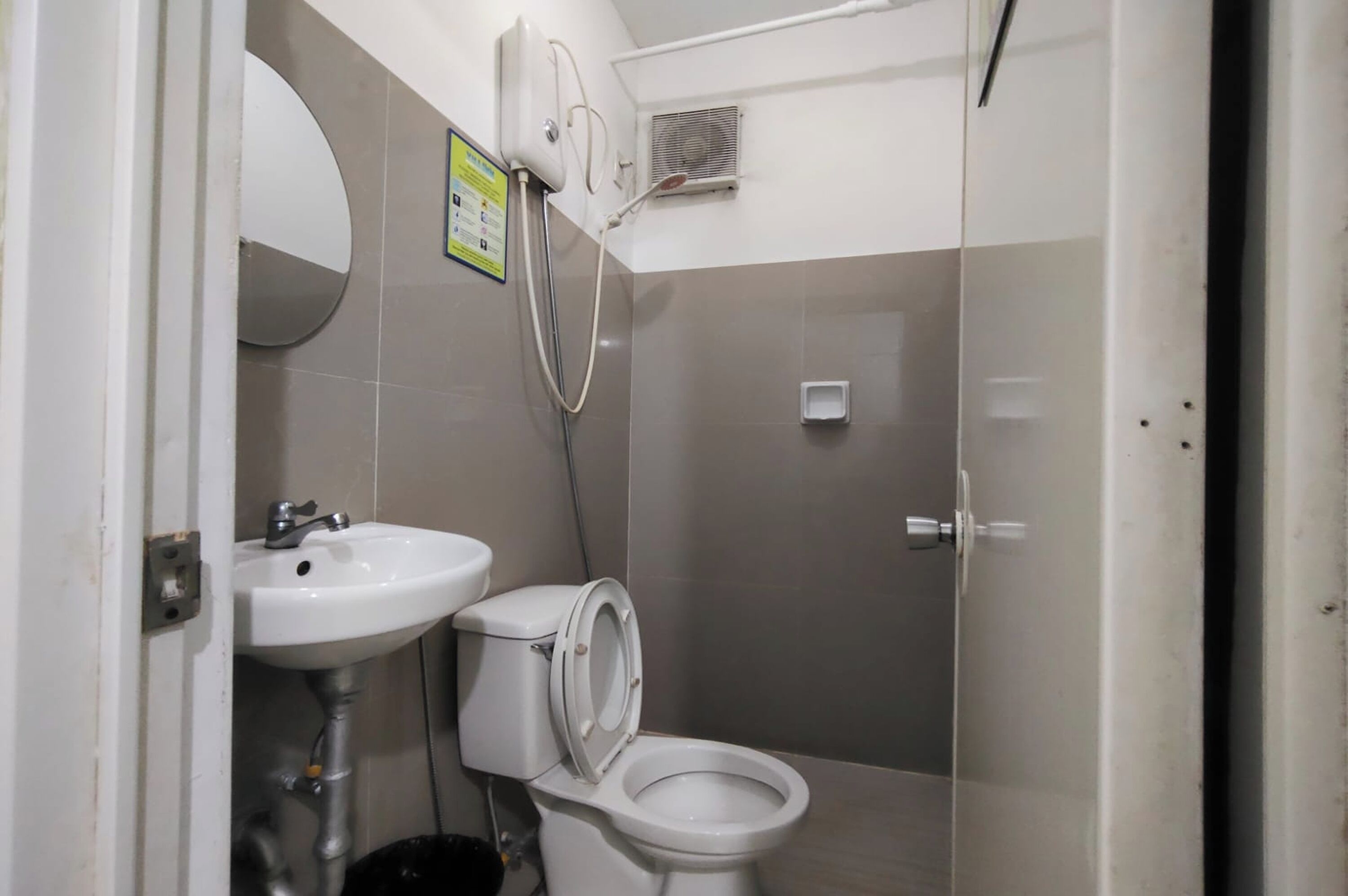 A bathroom with a sink, toilet, and shower.