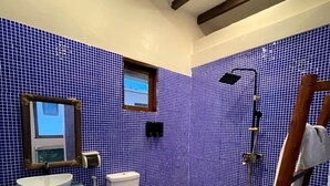 A bathroom with a blue tiled wall, a white sink, and a shower. - Asante Sana Beach Cottages - Beachfront Cottage (Fukuchani)