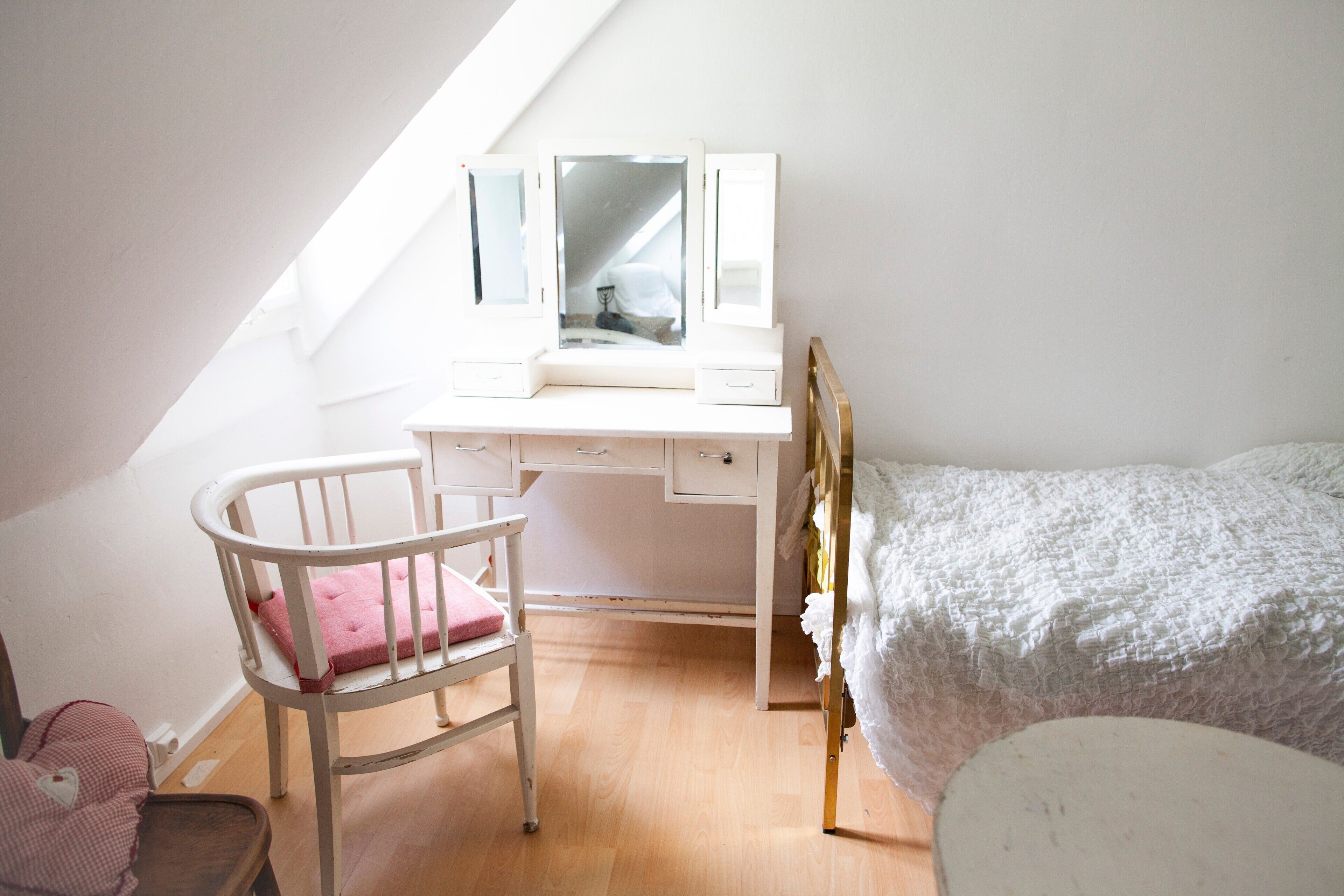 A child's bedroom with a desk, chair, and bed.