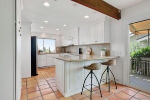Enjoy cooking in this well-equipped kitchen with a large island and bar stools.