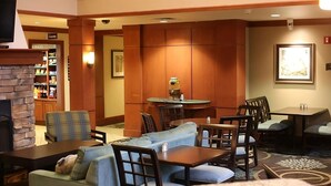 A hotel lobby with a fireplace, seating area, and a kitchenette. - Better Choice for your Vacation! 2 Posh Units, Free Breakfast, Outdoor Pool! (Vancouver)