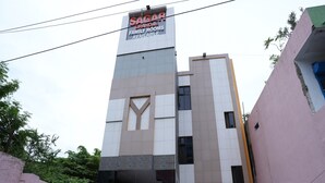 A building with a sign indicating 'SAGAR' and 'GRAND AC FAMILY ROOMS AVAILABLE'. - Sagar Grand (Puducherry)