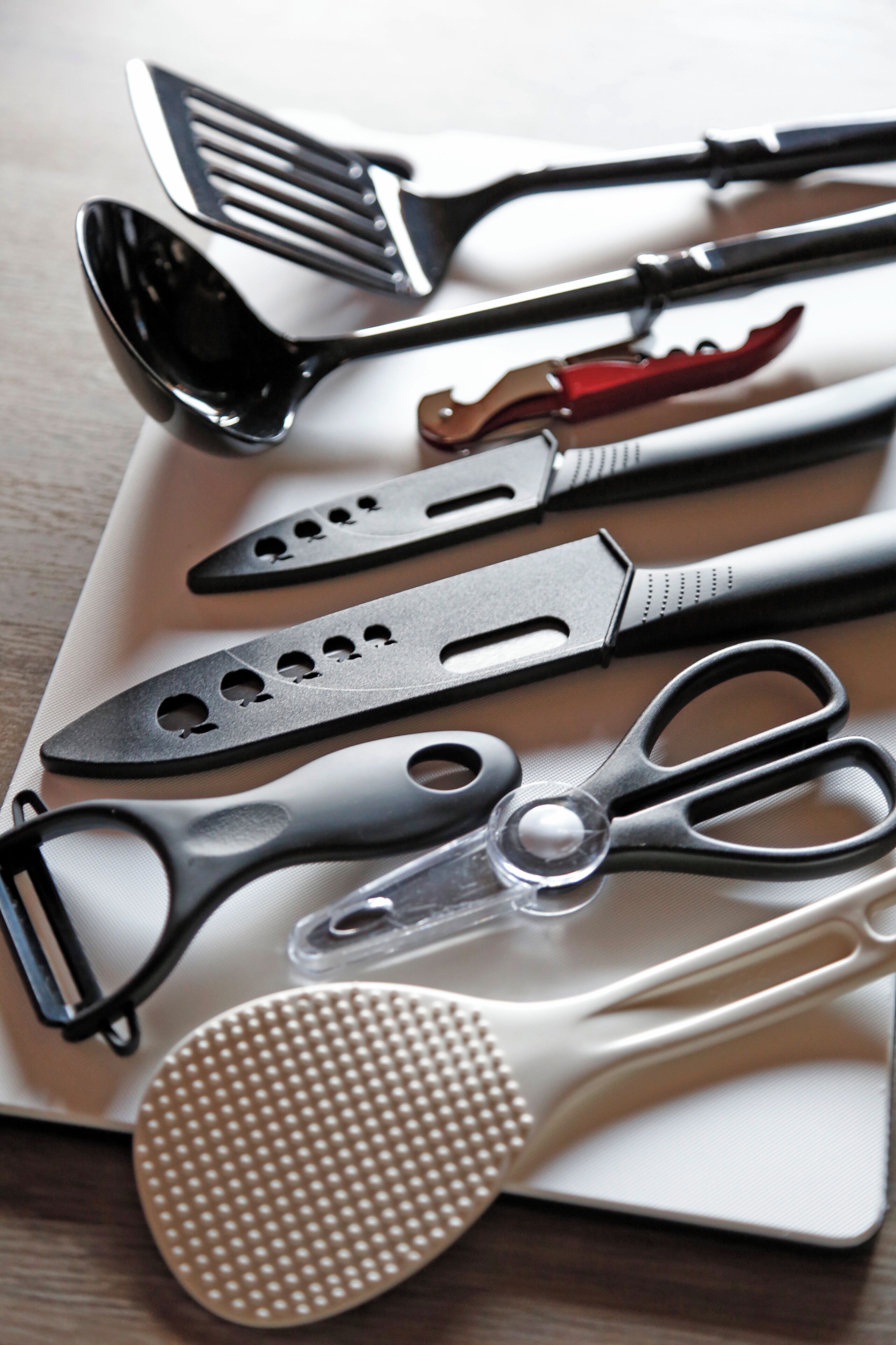 A collection of kitchen utensils on a white plate.