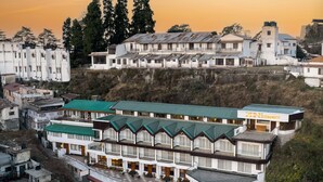 A multi-story hotel with a green roof, balconies, and a sign reading "ZINE CONNECT". - Zone Connect by The Park Mussoorie (Dehradun)