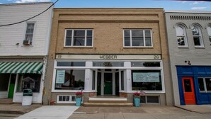A two-story building with the sign "WEBBER" above the entrance. - Webber Hotel (Lyndonville)