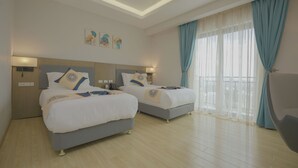 A hotel room with two beds, a large window with curtains, and artwork on the wall. - Stay Easy Plus Hotel (Addis Ababa)