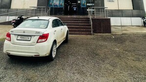 A building with a sign for OM Jee Cinemas and a 'bookmyshow' banner. - Hotel Primrose - Patiala (Pantran)