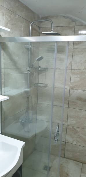 A glass-enclosed shower with a handheld showerhead and a wall-mounted faucet. - Taksim Millennium Suites (Istanbul)