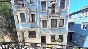 A multi-story building with balconies, a visible ground floor entrance, and a clear sky. - Taksim Millennium Suites (Istanbul)