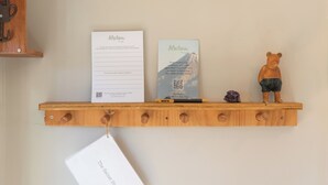 A wooden shelf with two cards, a bear figurine, and a tag. - The Secret Studio, Outdoor Bath & Pizza Oven (New Plymouth)