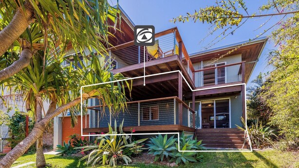 A modern two-story house with a balcony, surrounded by lush greenery and palm trees. - Pacifica 2 - Brooms Head (Brooms Head)