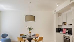A modern kitchen with white cabinets, a black countertop, and a built-in oven. - Riviera Flavour Apartments by Wonderful Italy - Ginestra (Santa Margherita Ligure)