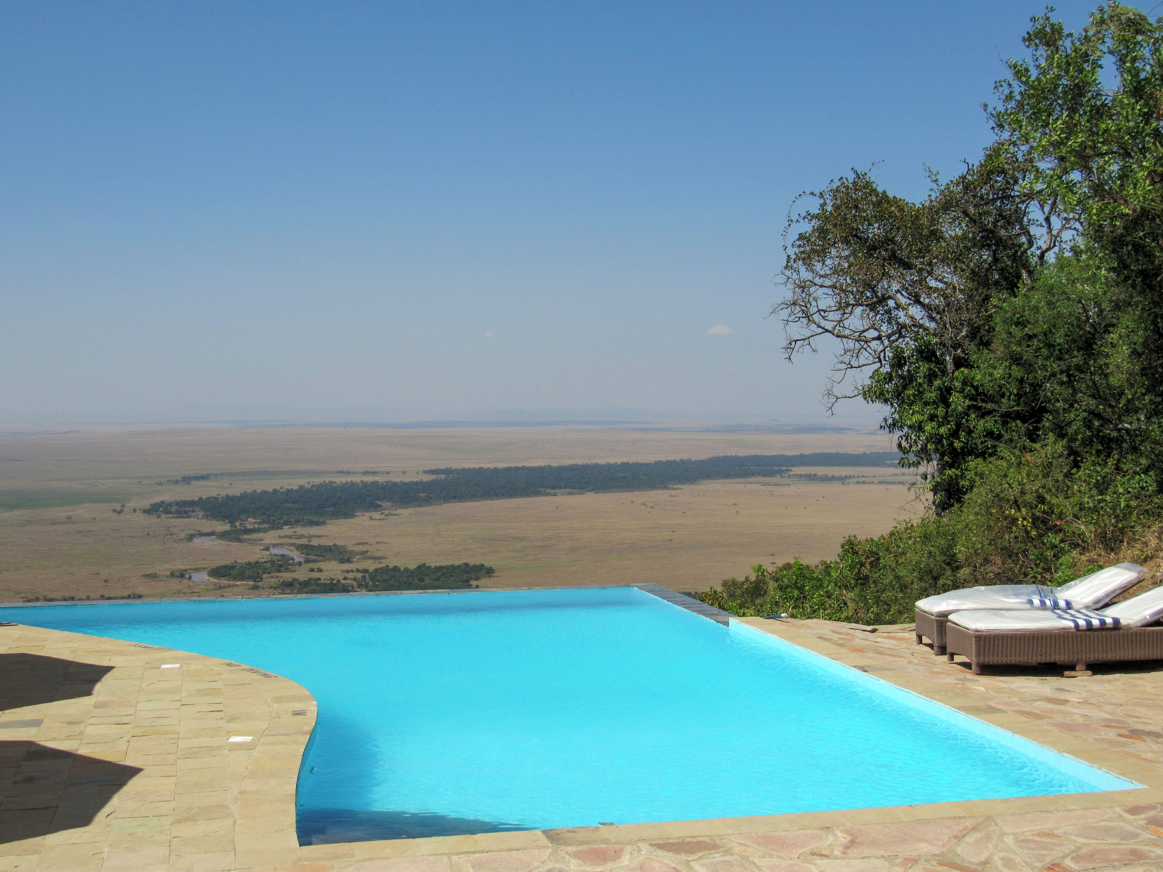 A swimming pool with a view of a vast landscape.