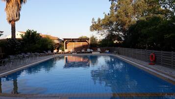 Seasonal outdoor pool, open 10:00 AM to 8:00 PM, pool umbrellas