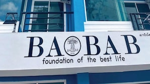 A hotel building with a sign that reads "BAOBAB foundation of the best life." - BAOBAB (Patong)