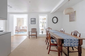 Enjoy meals with family and friends in this spacious dining area, complete with a long table and matching chairs.