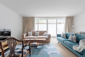 Relax in this inviting living room with a sofa, coffee table, and large window.